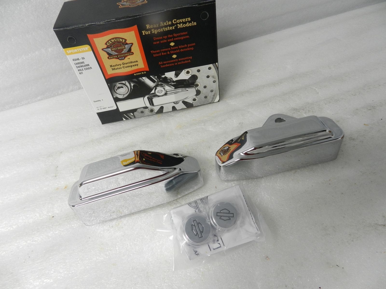 45448-04 NEW OEM 2004 AND NEWER HARLEY-DAVIDSON SPORTSTER CHROME AXLE COVER KIT